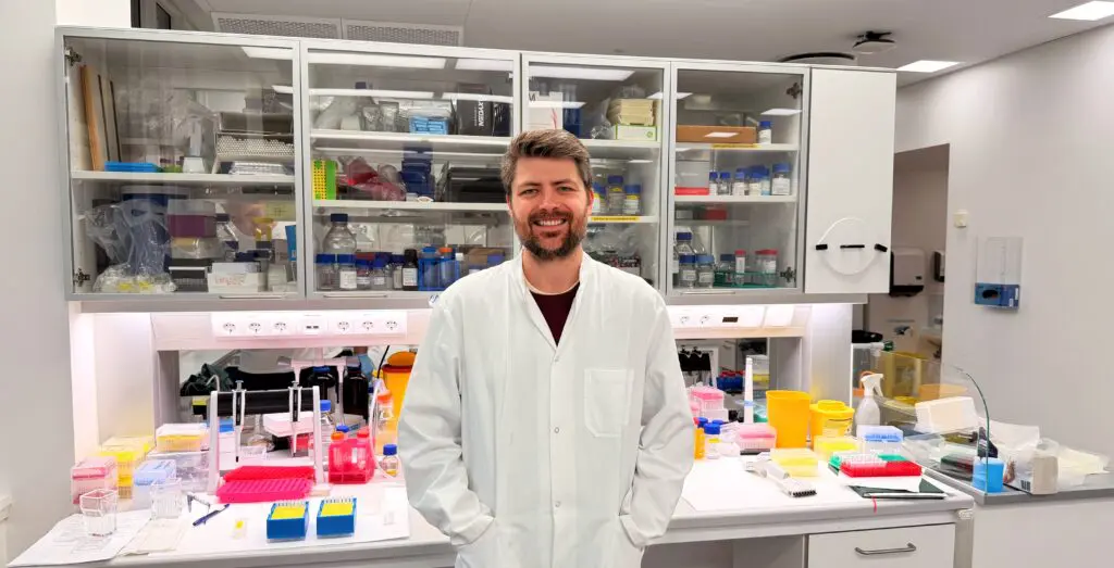 Dr. Luke Gamon, an Assistant Professor at the University of Copenhagen, smiling in Lab for an interview piece with IonOpicks about their UHPLC Columns
